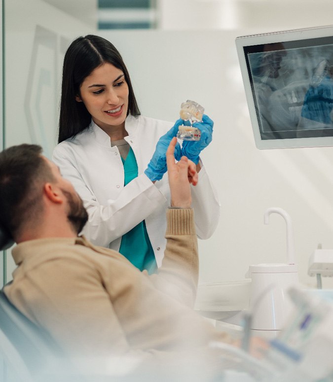Patient learning how dental implants work in Englewood