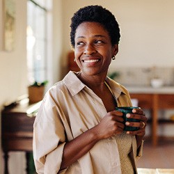 Smiling woman enjoying coffee at home
