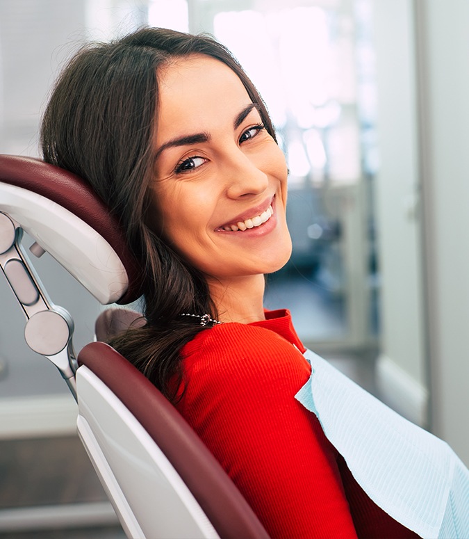 Comfortable woman in dental chair smiling