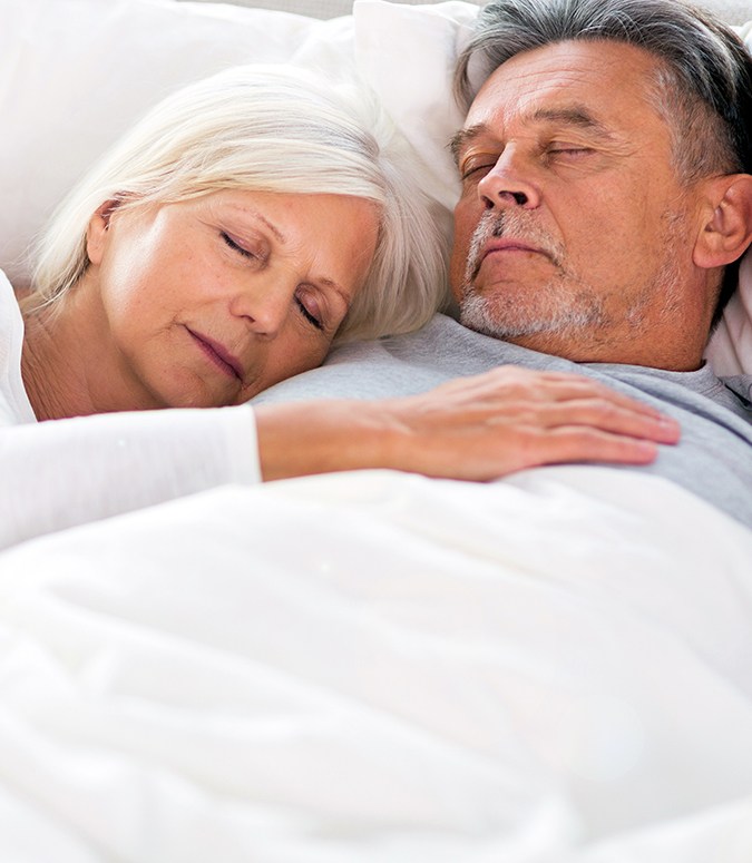 Man and woman sleeping soundly thanks to sleep apnea treatment