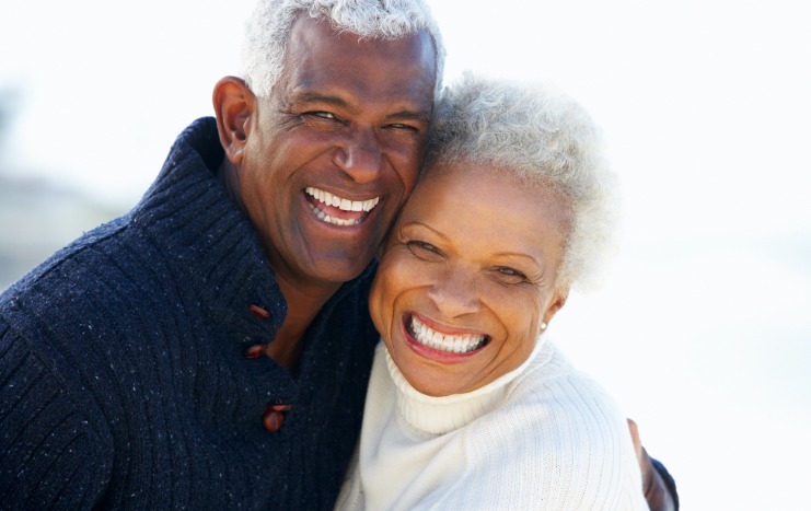 Man and woman with healthy smiles after preventive dentistry