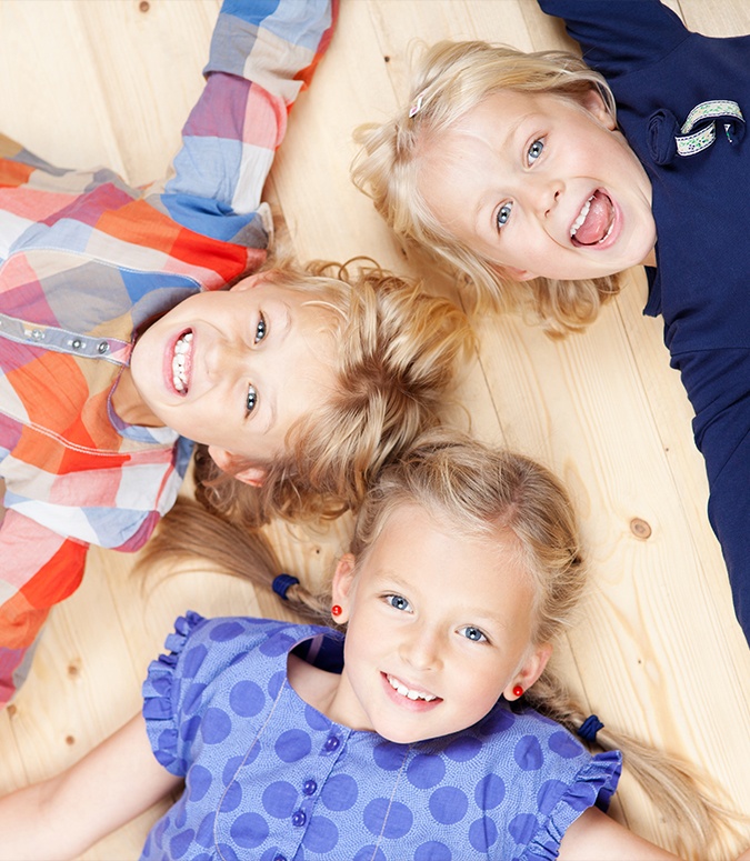 Three kids smiling after children's dentistry visit