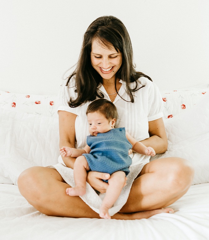 Mother holding an infant after frenectomy for lip and tongue tie