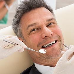 Man smiling at dentist in Englewood