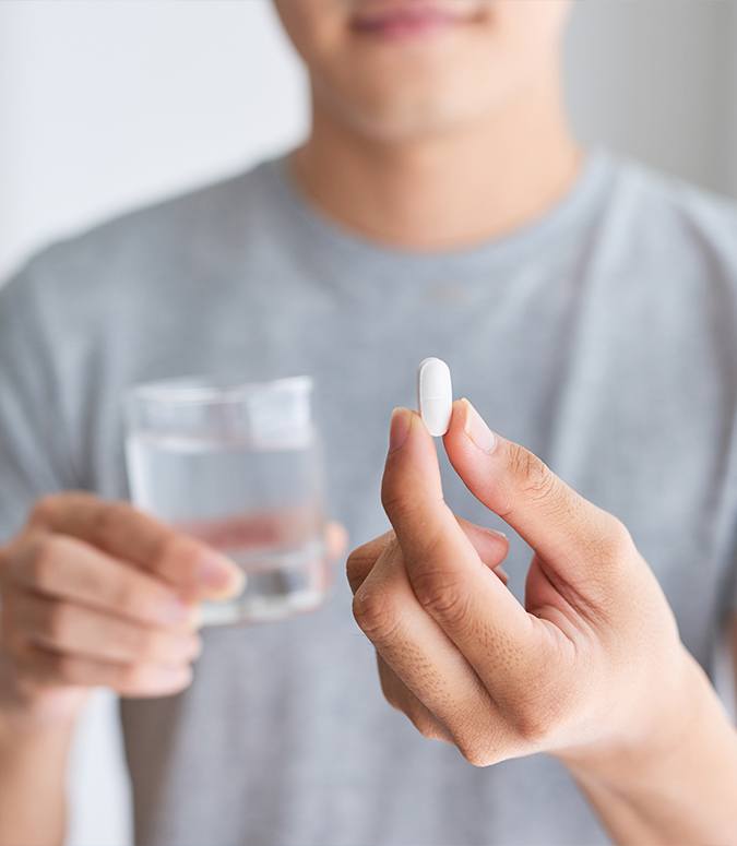 Man taking an oral conscious dental sedation pill