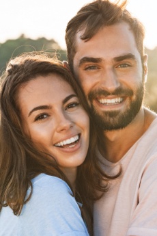 Man and woman with healthy smiles after preventive dentistry