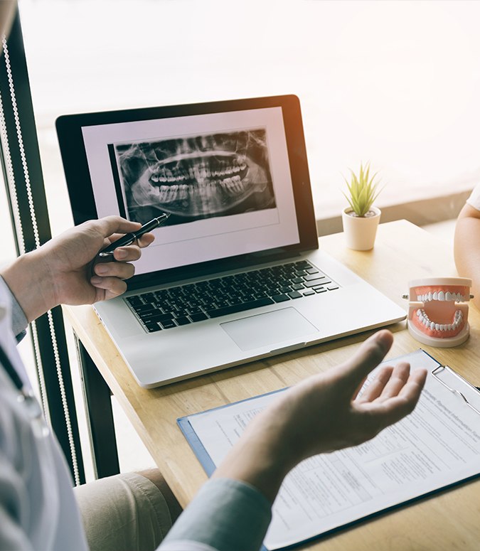 Dentist and patient reviewing digital x-rays