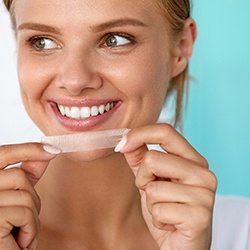 woman holding whitening strips