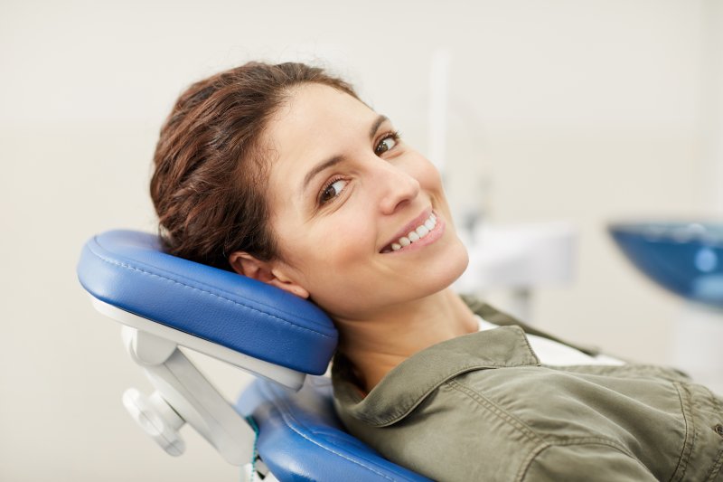 young woman smiling in dentist chair