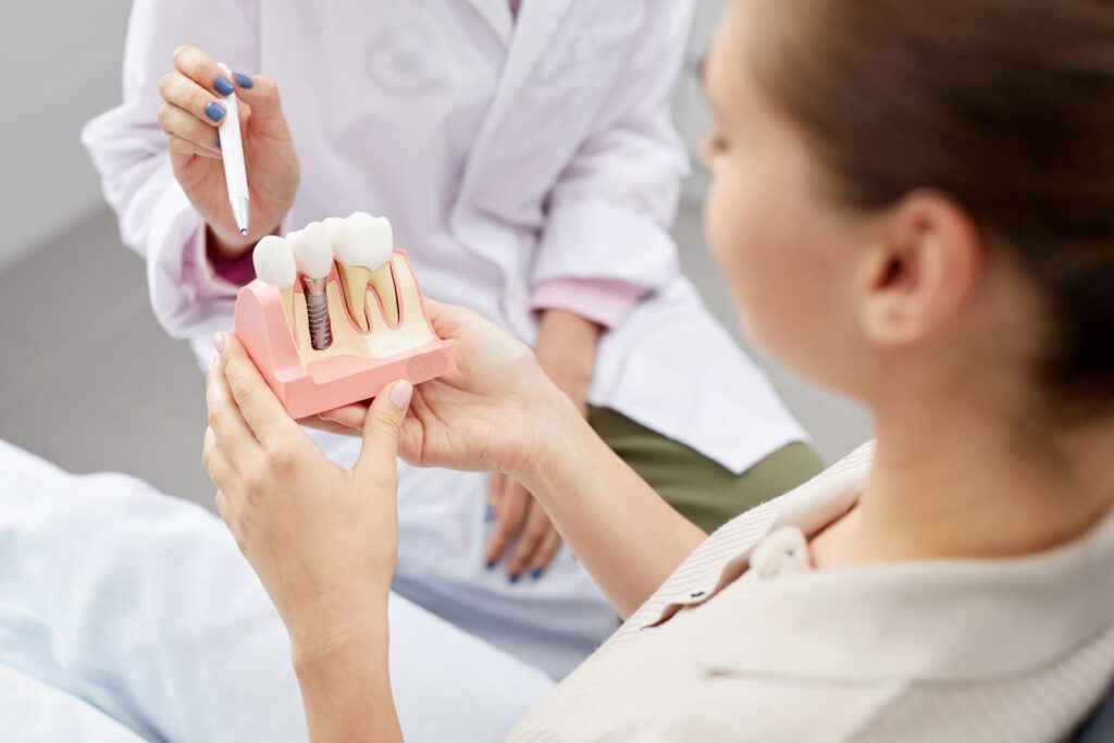 A woman at a dental implant consultation with her dentist